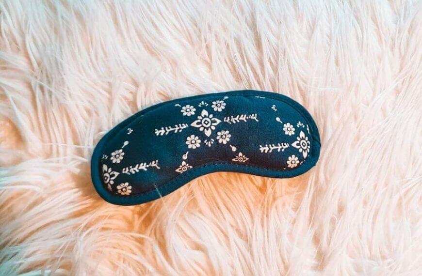 flower pattern on an eyemask on a fluffy pillow
