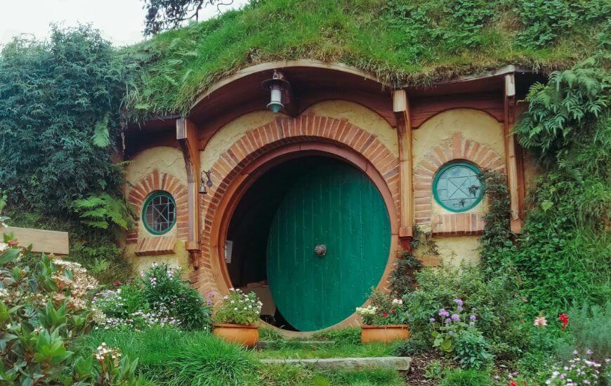 hobbiton house with green door and plants