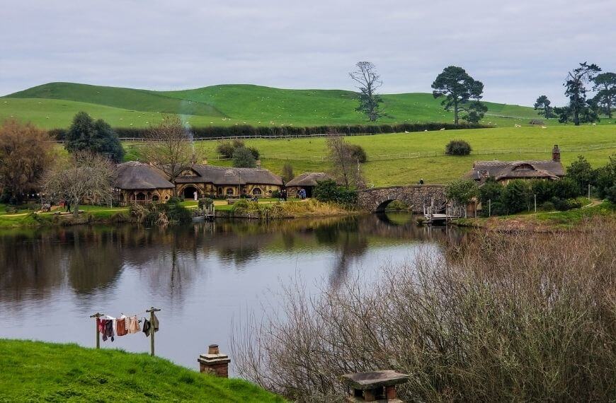 the view when visiting hobbiton including the lake and pub