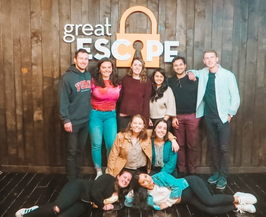 group of friends posing outside of an escape room