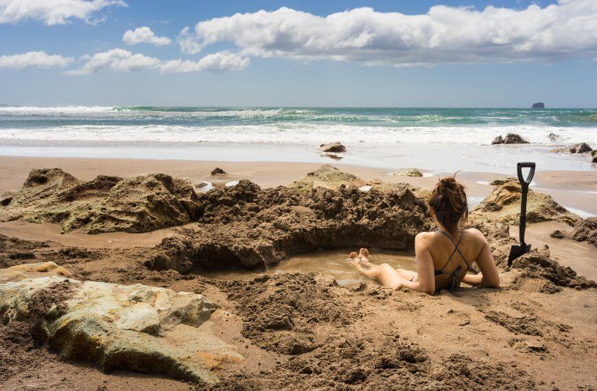 hot pool in new zealand with girl using the hot geothermal water