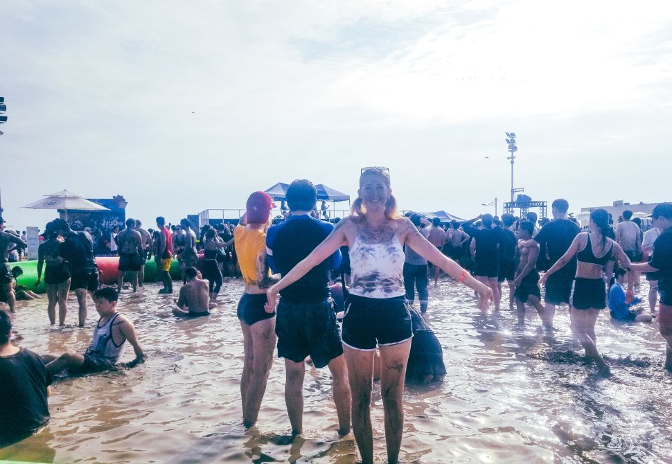 Me standing in mud at the festival of Mud