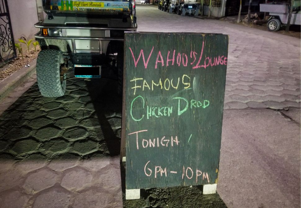 Sign outside the Wahoo Lounge for the weekly chicken poop bingo board game - San Pedro 