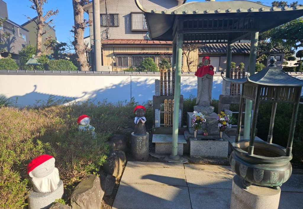 You'll find these other small statues and traditional red bibs scattered throughout the garden