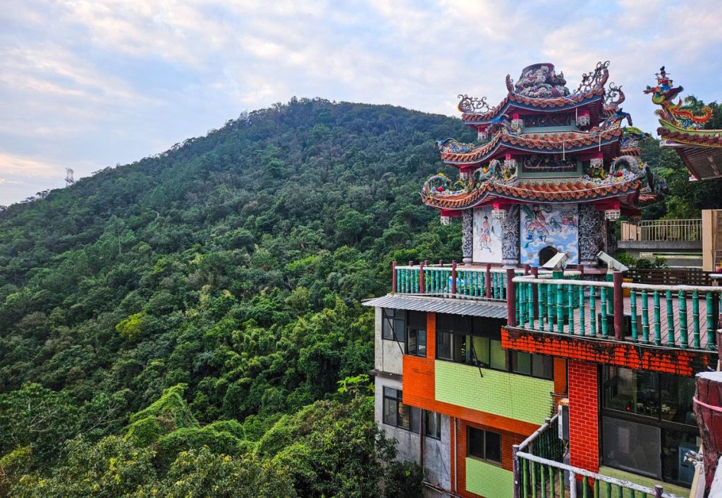 The side view of the temple against the dense jungle and mountain