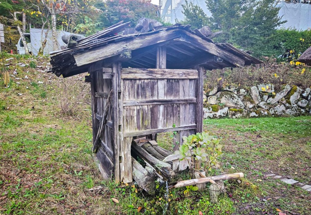 Old wooden structures for storing and farm life are found throughout the village