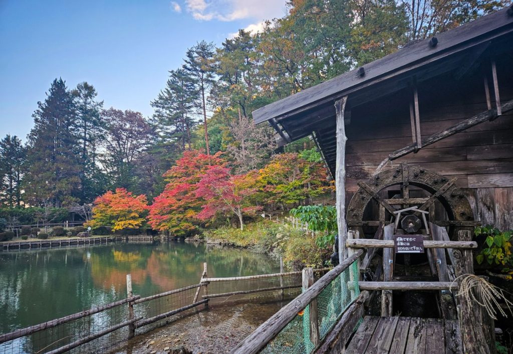 Watermill on the side of a traditional wooden farmhouse